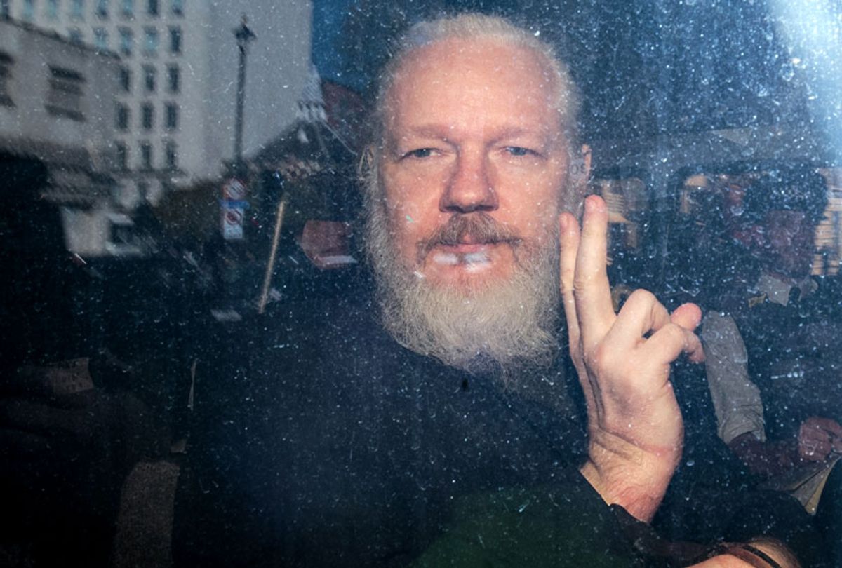 Julian Assange gestures to the media from a police vehicle on his arrival at Westminster Magistrates court on April 11, 2019 in London, England. (Getty Images/Jack Taylor)