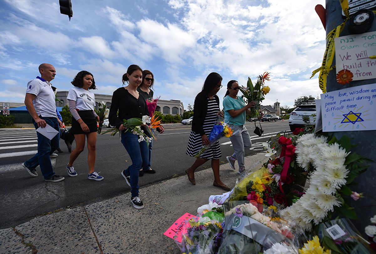A group of Poway residents bring flowers and cards to a memorial outside of the Chabad of Poway synagogue, Sunday, April 28, 2019, in Poway, Calif. A man opened fire Saturday inside the synagogue near San Diego as worshippers celebrated the last day of a major Jewish holiday. (AP Photo/Denis Poroy) ((AP Photo/Denis Poroy))