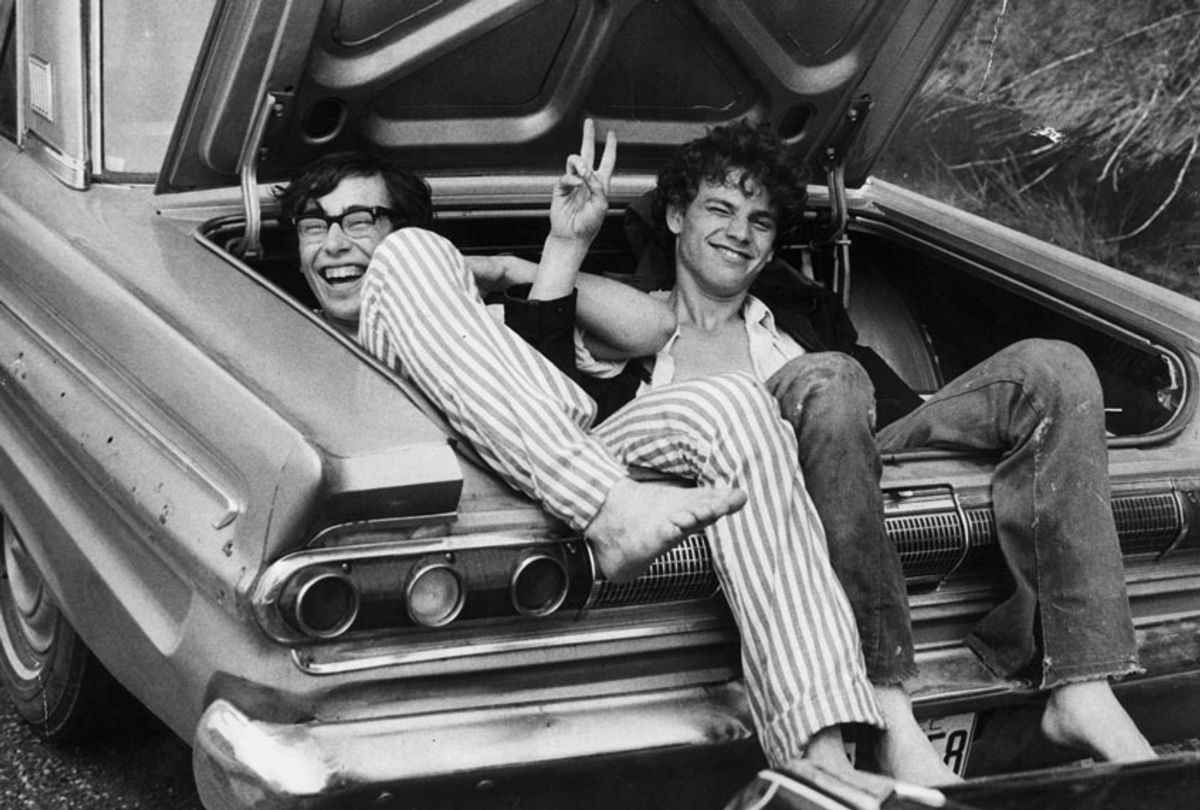 Two young men in the boot of a car after hitching a lift home from the Woodstock Music and Arts Fair, August 1969. (Getty Images/Three Lions)