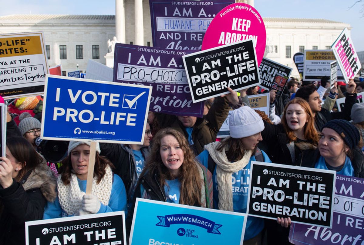 Pro-choice activists hold signs in response to anti-abortion activists participating in the "March for Life," an annual event to mark the anniversary of the 1973 Supreme Court case Roe v. Wade, which legalized abortion in the US, outside the US Supreme Court in Washington, DC, January 18, 2019. (Getty/Saul Loeb)