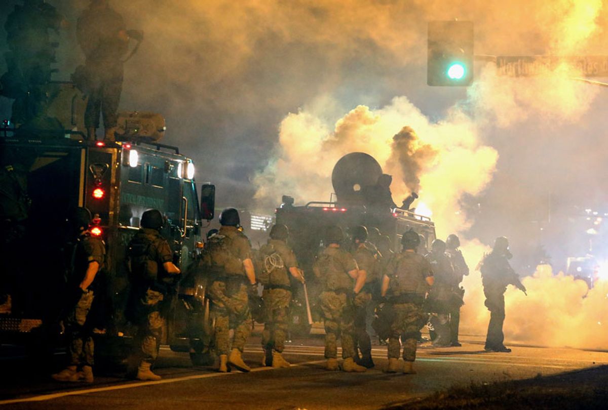 Police attempt to control demonstrators protesting the killing of teenager Michael Brown on August 18, 2014 in Ferguson, Missouri.  (Getty/Scott Olson)