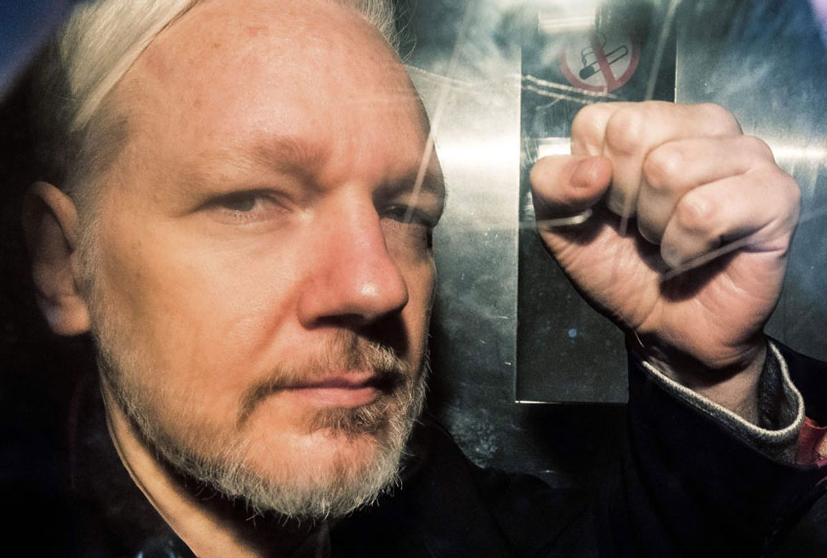 WikiLeaks founder Julian Assange gestures from the window of a prison van as he is driven into Southwark Crown Court in London on May 1, 2019. (Getty/Daniel Leal-Olivas)