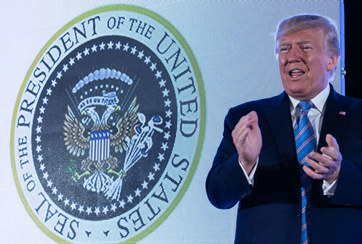 U.S. President Donald Trump stands next to a surreptitiously altered presidential seal as he arrives to address the Turning Point USAs Teen Student Action Summit 2019 in Washington, DC, on July 23, 2019. (Getty/Nicholas Kamm)