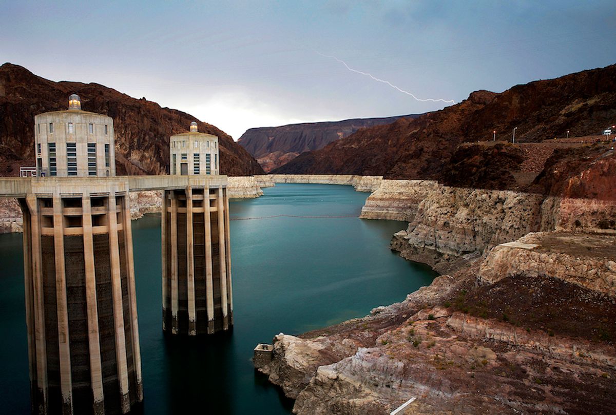 FILE - In this July 28, 2014, file photo, lightning strikes over Lake Mead near Hoover Dam that impounds Colorado River water at the Lake Mead National Recreation Area in Arizona. President Donald Trump on Tuesday, April 16, 2019, signed a plan to cut back on the use of water from the Colorado River, which serves 40 million people in the U.S. West. (AP Photo/John Locher, File) (AP Photo/John Locher, File)
