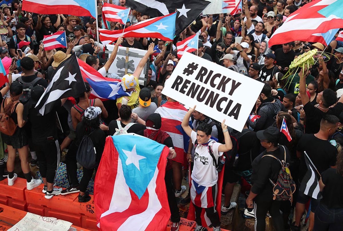 Protesters demonstrate against Ricardo Rossello, the Governor of Puerto Rico, near police that are manning a barricade set up along a street leading to the governor's mansion on July 22, 2019 in Old San Juan, Puerto Rico.  (Getty/Joe Raedle)