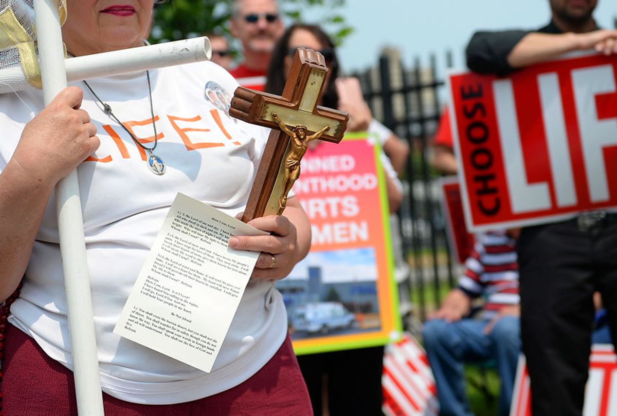 A pro-life supporter holds a crucifix during a demonstration outside the Planned Parenthood Reproductive Health Services Center on May 31, 2019 in St Louis, Missouri.  (Getty/Michael Thomas)