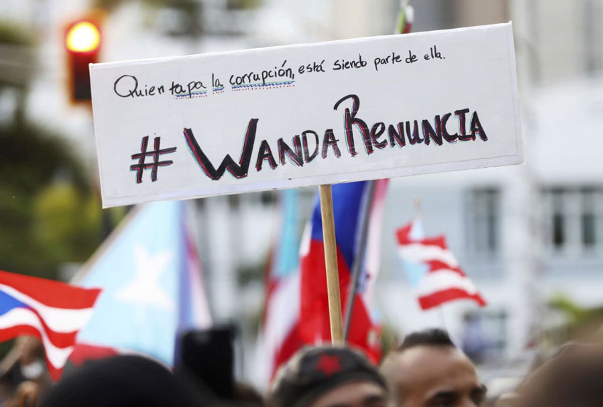 People demand the resignation of Justice Secretary Wanda Vazquez during a protest outside the Department of Justice in San Juan, Puerto Rico, Monday, July 29, 2019.  (AP/Brandon Cruz González)