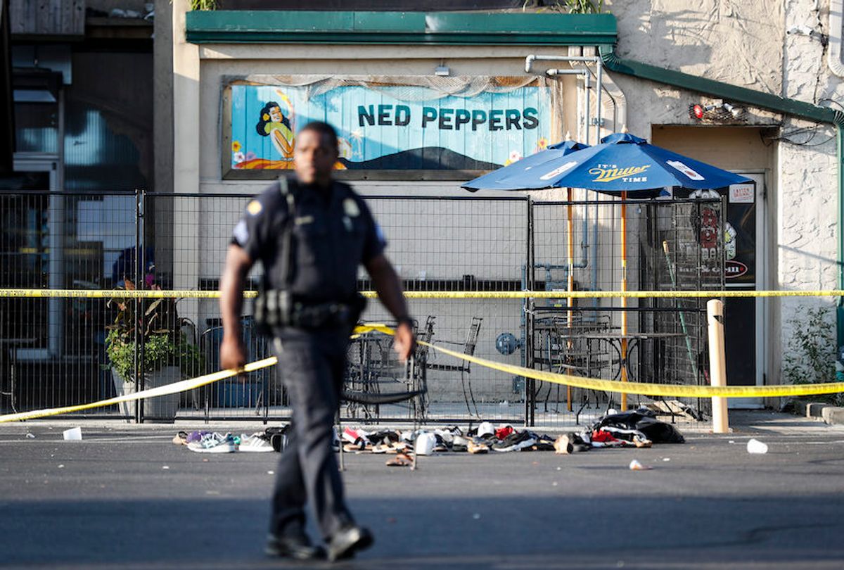 Shoes are piled outside the scene of a mass shooting including Ned Peppers bar, Sunday, Aug. 4, 2019, in Dayton, Ohio.  (AP/John Minchillo)