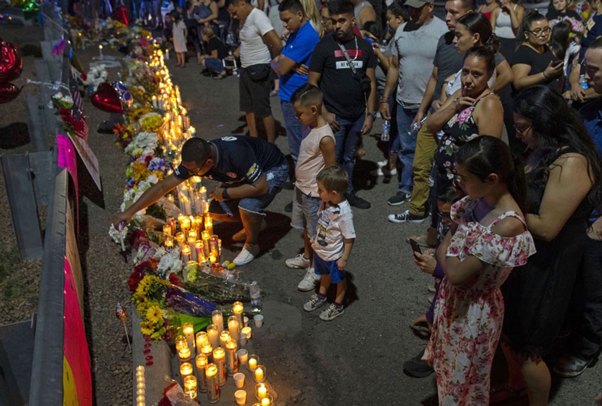 People gather at makeshift memorial for the victims of Saturday's mass shooting at a shopping complex in El Paso, Texas, Sunday, Aug. 4, 2019.  (AP/Andres Leighton)