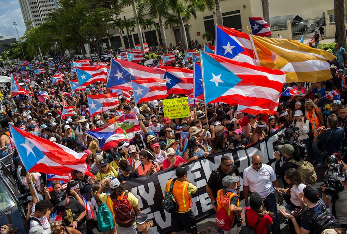 People gather to celebrate the resignation of Gov. Ricardo Rossello who announced that he is resigning Aug. 2 after weeks of protests in San Juan, Puerto Rico, Thursday, July 25, 2019. (AP Photo/Dennis M. Rivera Pichardo) (AP Photo/Dennis M. Rivera Pichardo)