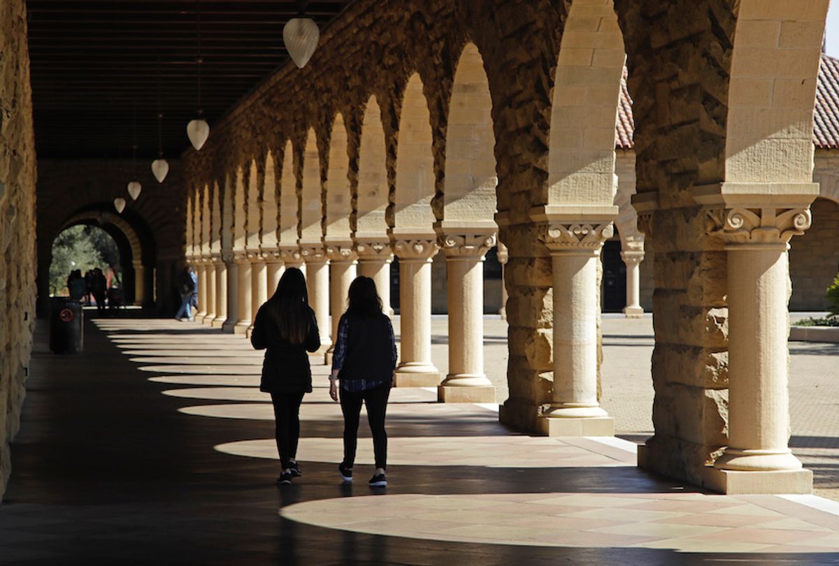 FILE - In this March 14, 2019, file photo students walk on the Stanford University campus in Stanford, Calif.  (AP Photo/Ben Margot, File)