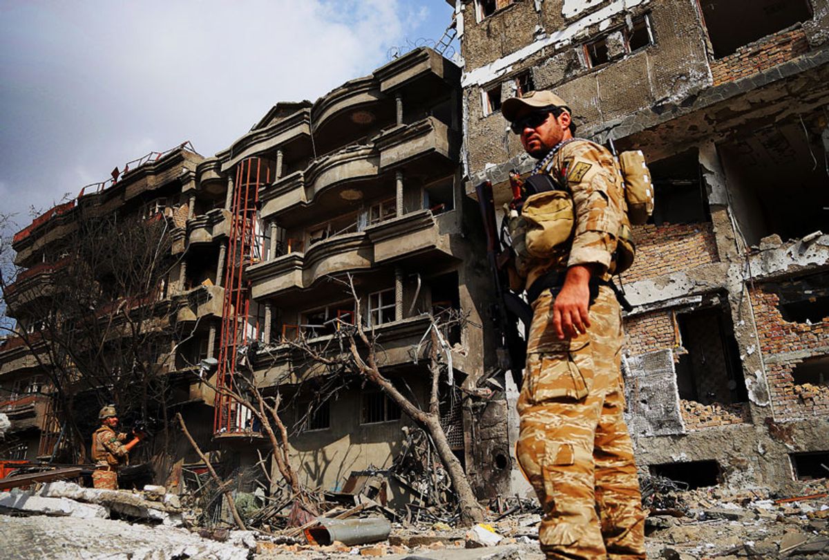 Afghan security forces inspect the aftermath of Sunday's attack in Kabul, Afghanistan, Monday, July 29, 2019. (AP Photo/Rahmat Gul)