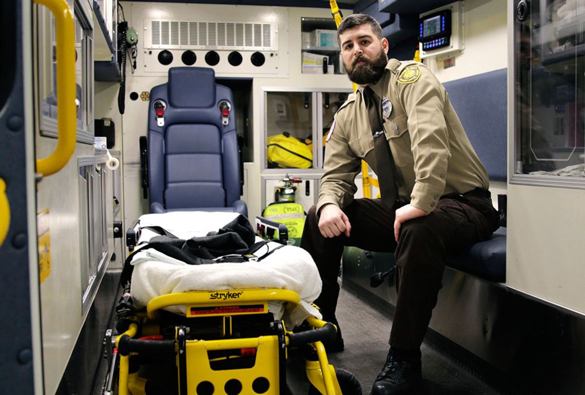 Boston Emergency Medical Services EMT Paul Mitchell sits in an ambulance at his station in the Hyde Park neighborhood of Boston. Mitchell, with bystander Carlos Arredondo and volunteer Devin Wang, are credited with helping to save the life of Jeff Bauman, who suffered traumatic injuries in the Boston Marathon bombings. (AP Photo/Charles Krupa)