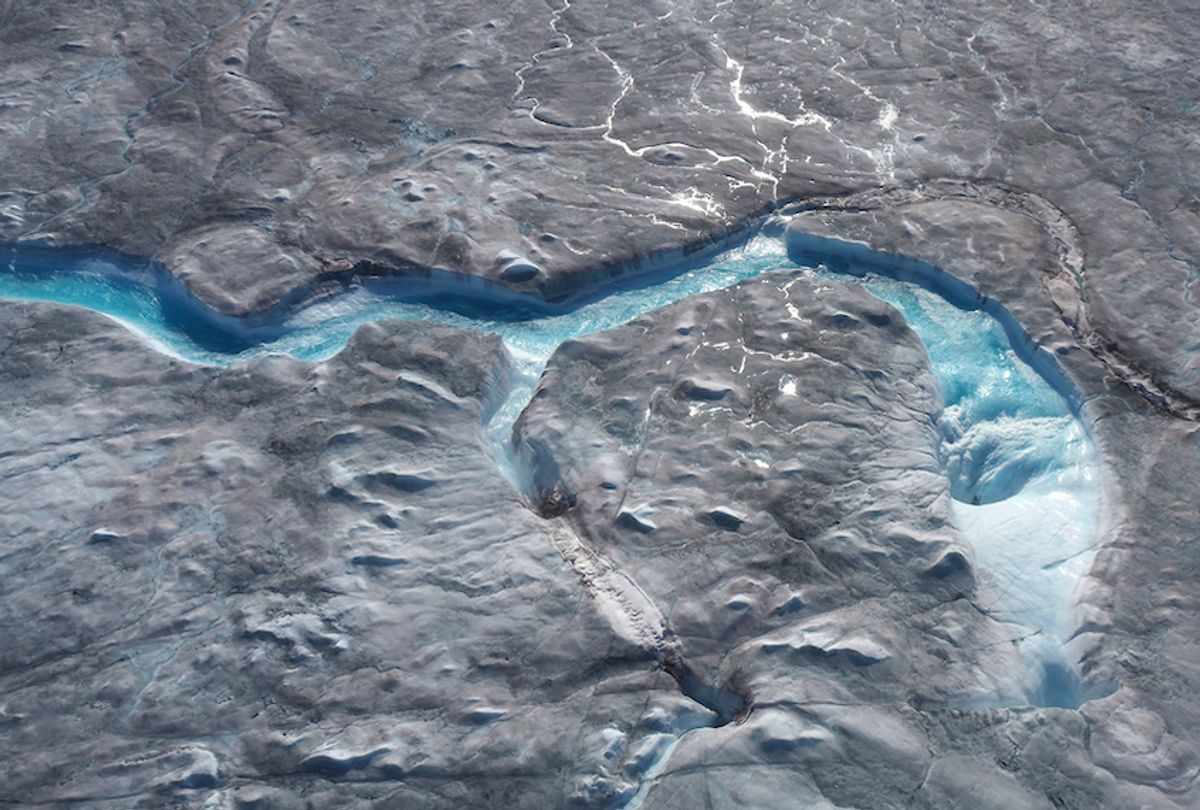 In this image taken on Thursday Aug.1, 2019 large rivers of melting water form on an ice sheet in western Greenland and drain into moulin holes that empty into the ocean from underneath the ice.  (Photo via Caspar Haarløv, Into the Ice via AP)