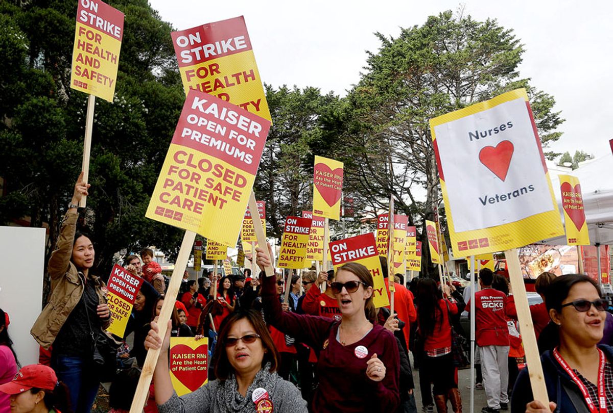 Registered nurses and supporters protest outside of a Kaiser Permanente facility in San Francisco, Tuesday, Nov. 11, 2014.  (AP Photo/Jeff Chiu)