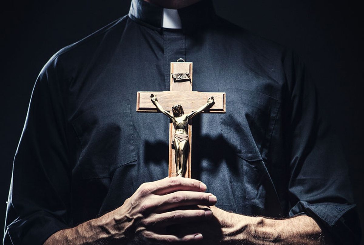 Catholic Priest Holding a Wooden Crucifix (Getty Images/ Ryan J Lane)