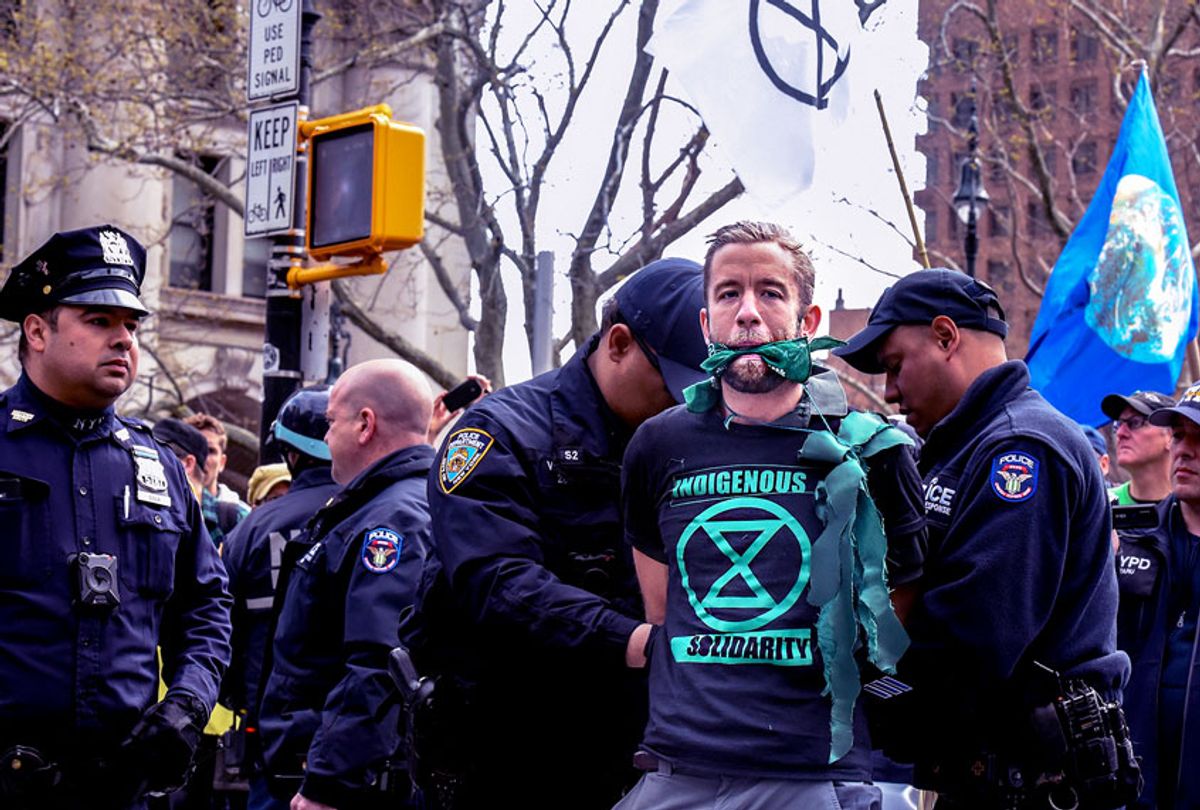 People are detained while participating in a direct action with a group protest organization called Extinction Rebellion on April 17, 2019 in New York City. The activists are demanding governments declare a climate emergency to combat pollution.  (Stephanie Keith/Getty Images)