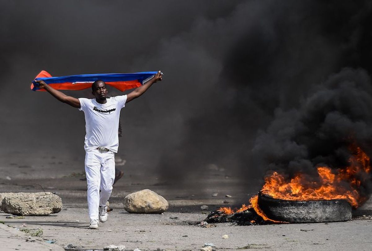 A demonstrator waves a Haitian flag during a protest outside United Nation's main base, against President Jovenel Moise on October 4, 2019 in Port-au-Prince, Haiti.  (Chandan Khanna//AFP via Getty Images)