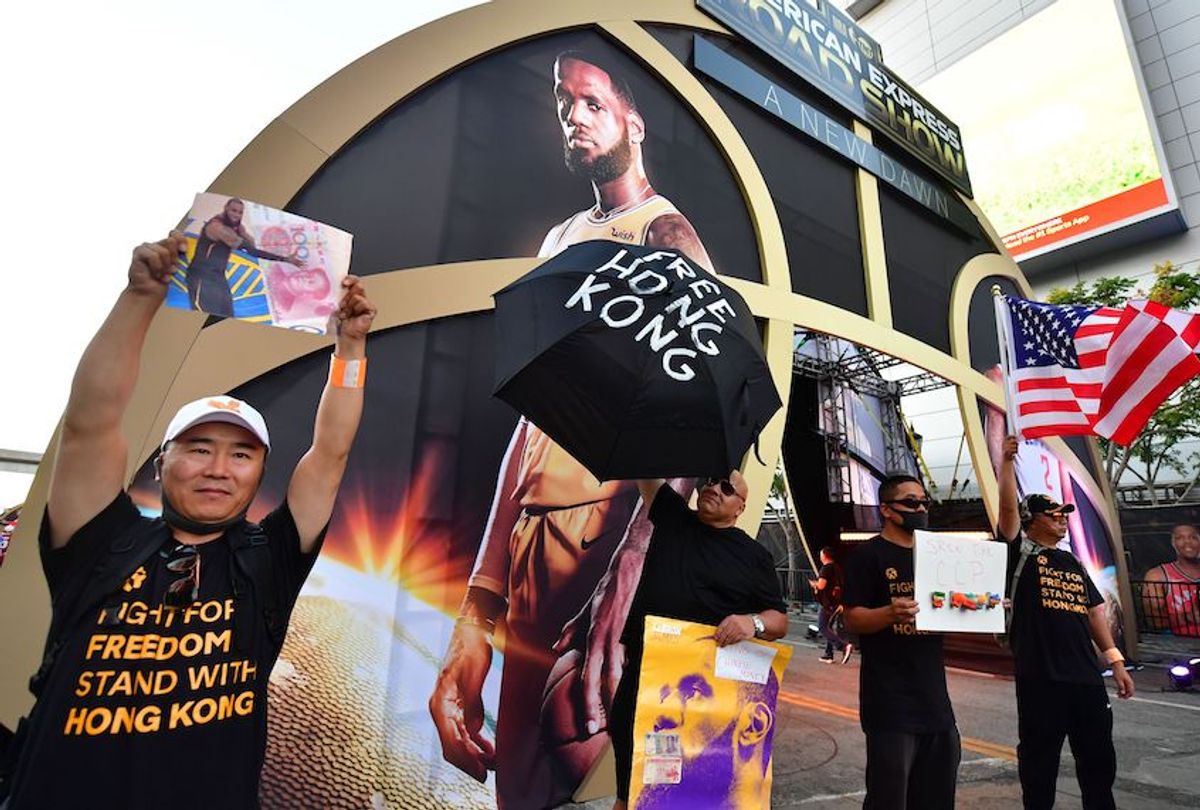 Hong Kong supporters protest outside Staples Center ahead of the Lakers vs Clippers NBA season opener in Los Angeles on October 22, 2019. - Activists handed out free T-shirts displaying support for the Hong Kong protests after an NBA fan in Northern California raised enough money to pay for more than 10,000 shirts, according to the organizer who goes by the pseudonym "Sun Lared" as LeBron James of the Lakers suffers the brunt of people's anger after comments he made in response to the tweet from Houston Rockets GM Daryl Morey in support of Hong Kong protesters, and drawing the ire of the Chinese Communist Pary. (Photo by Frederic J. BROWN / AFP) (Photo by FREDERIC J. BROWN/AFP via Getty Images) (Frederic J. Brown/AFP via Getty Images)
