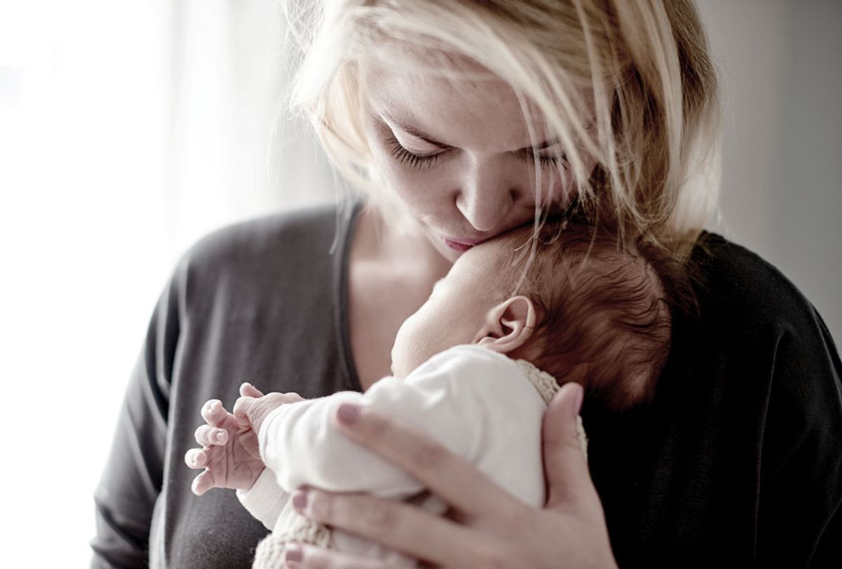 A mother spending time with her newborn baby (Getty Images/Mikolette)