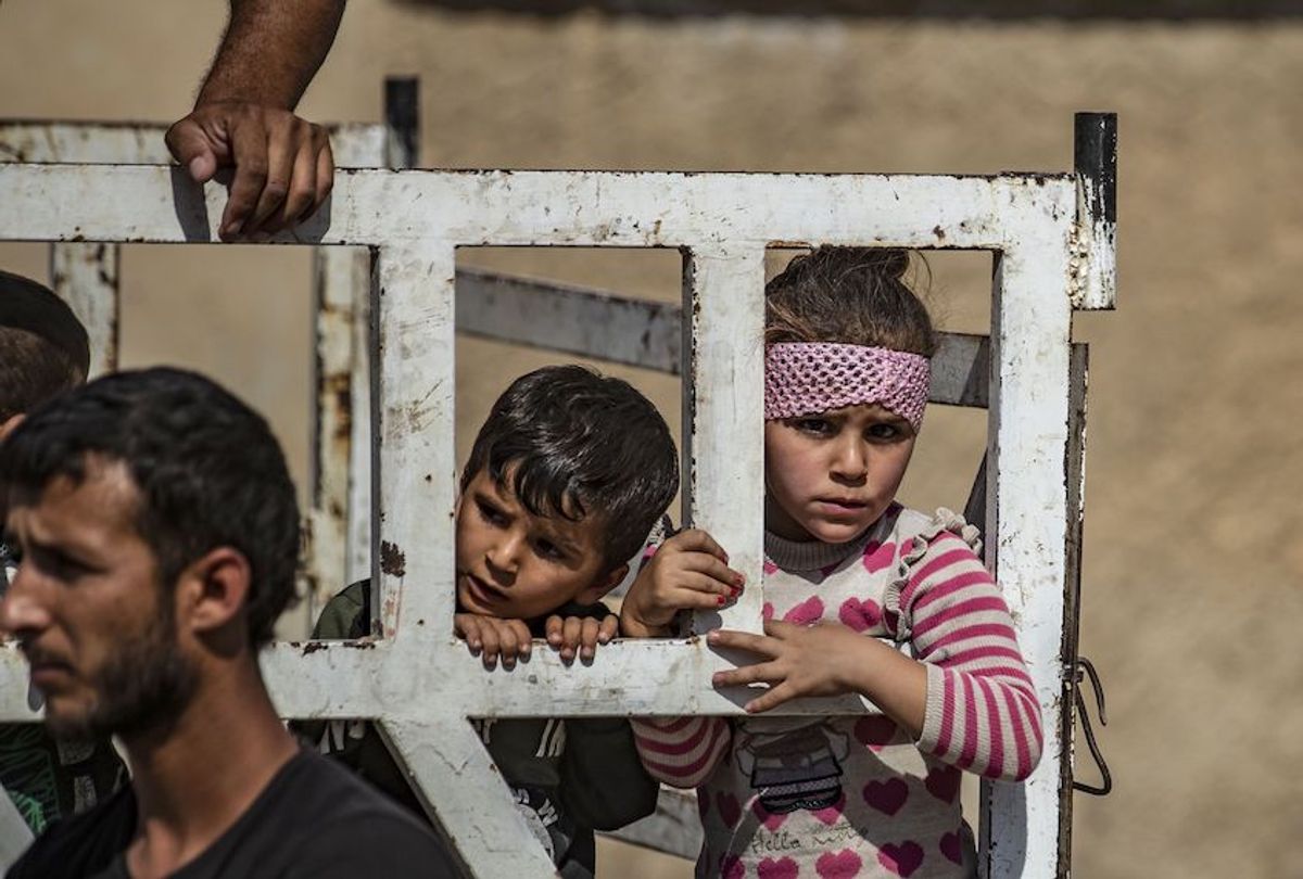 Syrian Arab and Kurdish civilians arrive to Hassakeh city after fleeing following Turkish bombardment on Syria's northeastern towns along the Turkish border on October 10, 2019. (Delil Souleiman/AFP aia Getty Images)