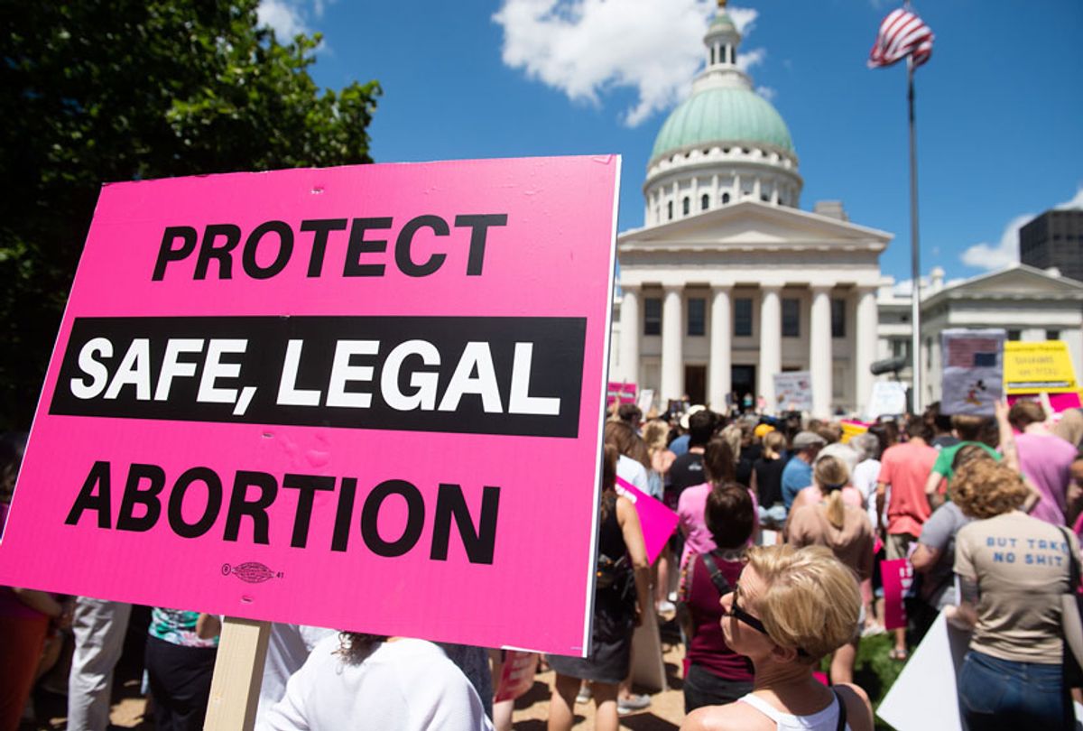 Protesters hold signs as they rally in support of Planned Parenthood and pro-choice (SAUL LOEB/AFP via Getty Images)
