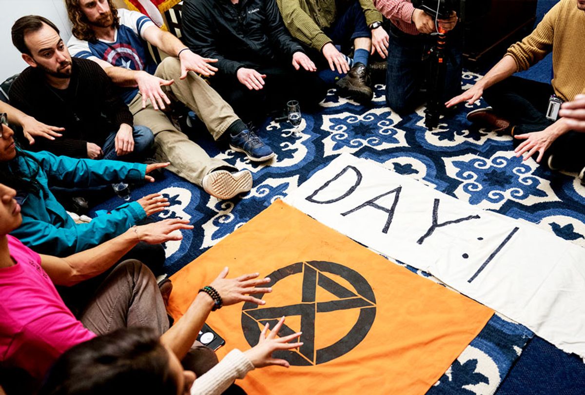 Extinction Rebellion protestors participate in a hunger strike and "grief session" in House Speaker Nancy Pelosi's Office in Longworth House Office Building on November 18, 2019 in Washington, DC. The strike is planned to be held all week or until Speaker Pelosi agrees to sit with the group for a one hour on-camera interview about climate change.  (Sarah Silbiger/Getty Images)