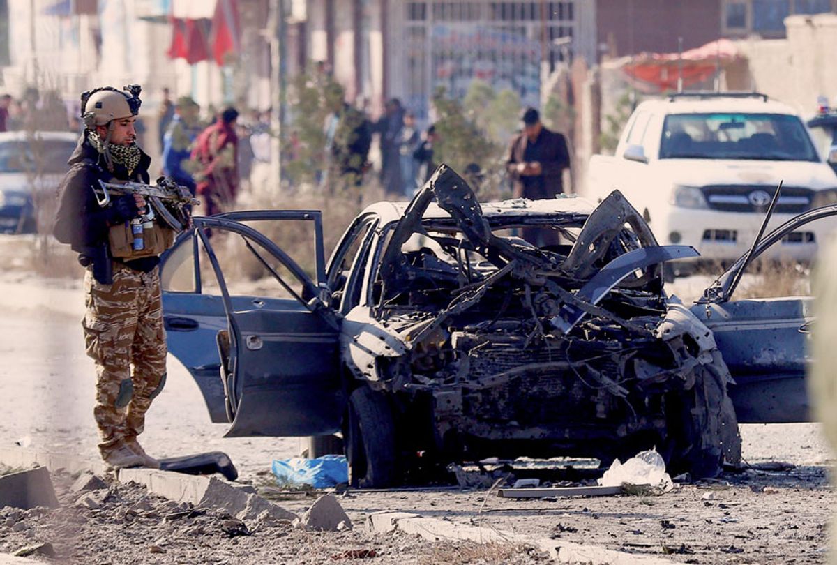 A soldier stands next to the site of a suicide attack in Kabul on November 13, 2019. - At least seven people were killed and seven wounded when a car bomb detonated during Kabul's busy morning rush hour on November 13, an interior ministry spokesman said. (Photo by STR / AFP) (Photo by  (STR/AFP via Getty Images)
