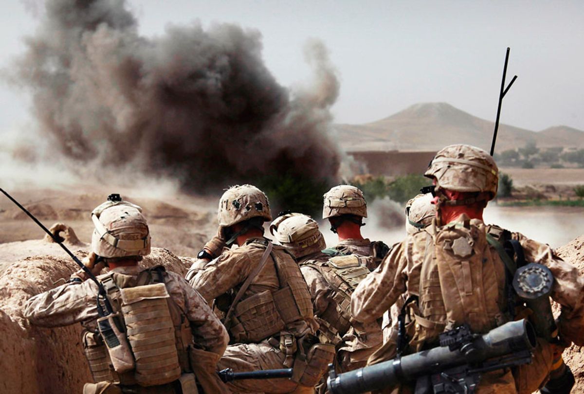 United States Marines from Bravo Company of the 1st Battalion of the 2nd Marines watch the explosion after calling in an airstrike during a gunbattle as part of an operation to clear the area of insurgents near Musa Qaleh, in northern Helmand Province, southern Afghanistan (AP Photo/Kevin Frayer)