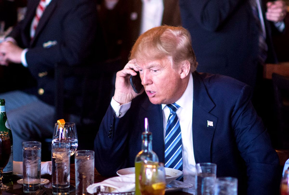 Republican presidential candidate Donald Trump talks talks on the phone while making a stop for lunch between campaign events at Fratello's Italian Tavern in North Charleston, SC on Thursday Feb. 18, 2016.  (Jabin Botsford/The Washington Post via Getty Images)