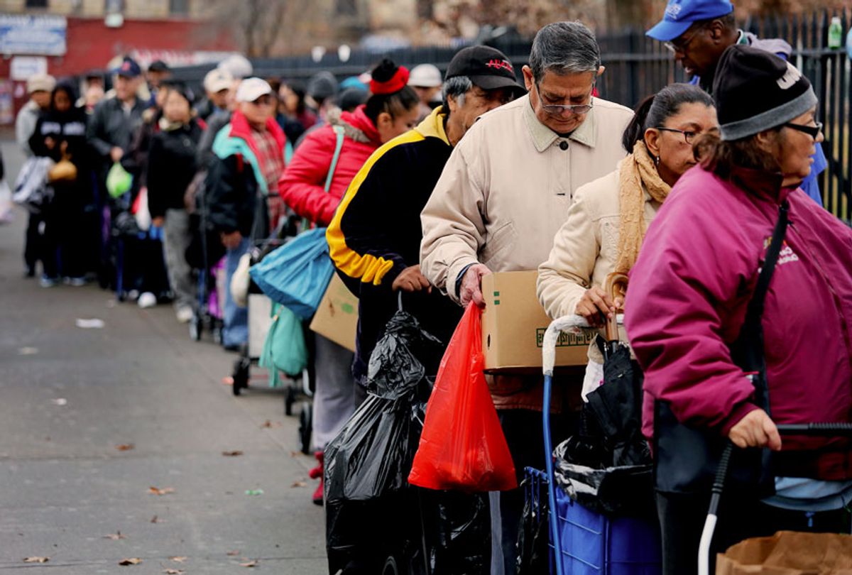 Brooklyn residents receive free food as part of a Bowery Mission outreach program on December 5, 2013 in the Brooklyn borough of New York City. The Christan ministry says it have seen a spike in need since food stamps to low-income families were reduced in November with cuts to the federal Supplemental Nutrition Assistance Program (SNAP). (John Moore/Getty Images)