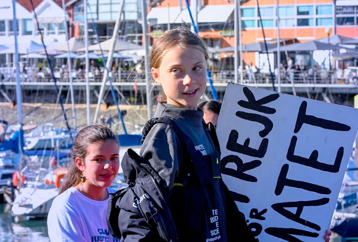 Swedish teen climate activist Greta Thunberg carries the placard "School strike for the climate" which she held outside the Swedish parliament, upon her arrival in Santo Amaro Recreation dock on December 03, 2019 in Lisbon, Portugal. Greta Thunberg sailed from Norfolk, Virginia, USA , accompanied by her father Svante Thunberg on the French built Outremer 45 catamaran La Vagabonde, skippered by Australian Riley Whitelum, and is on her way to attend COP25 in Madrid, Spain. (Horacio Villalobos/Getty Images)