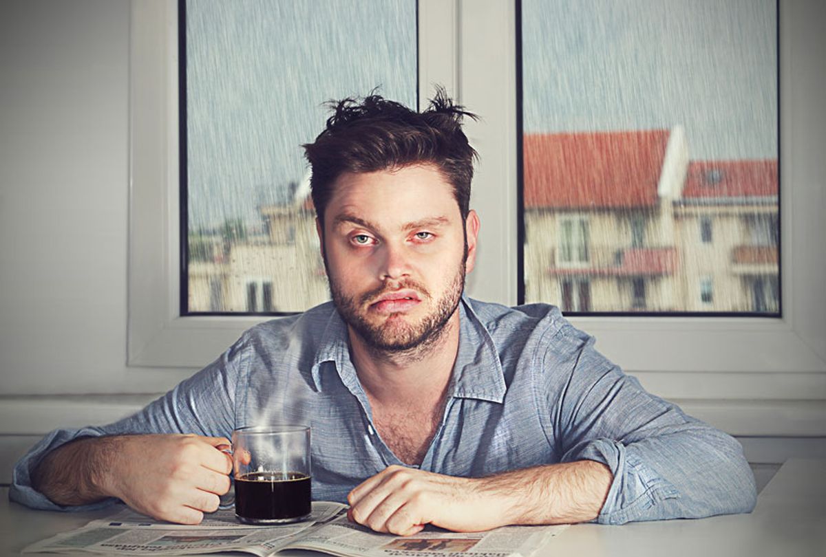 Grumpy hungover man with coffee (Getty Images)