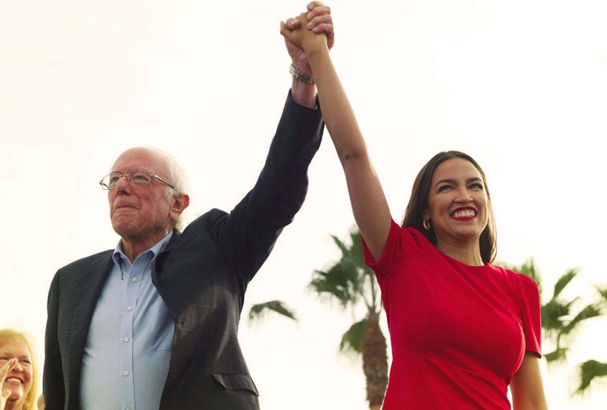 Democratic presidential candidate Sen. Bernie Sanders, I-Vt., and Rep. Alexandria Ocasio-Cortez, D-N.Y., greet the crowd during a rally in Venice, Calif., Saturday, Dec. 21, 2019. (AP Photo/Kelvin Kuo)
