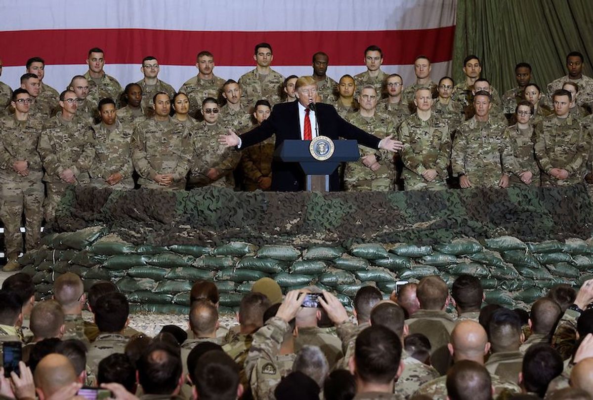 In this file photo taken on November 28, 2019, US President Donald Trump speaks to the troops during a surprise Thanksgiving day visit at Bagram Air Field in Afghanistan.  (Olivier Douliery/AFP via Getty Images)