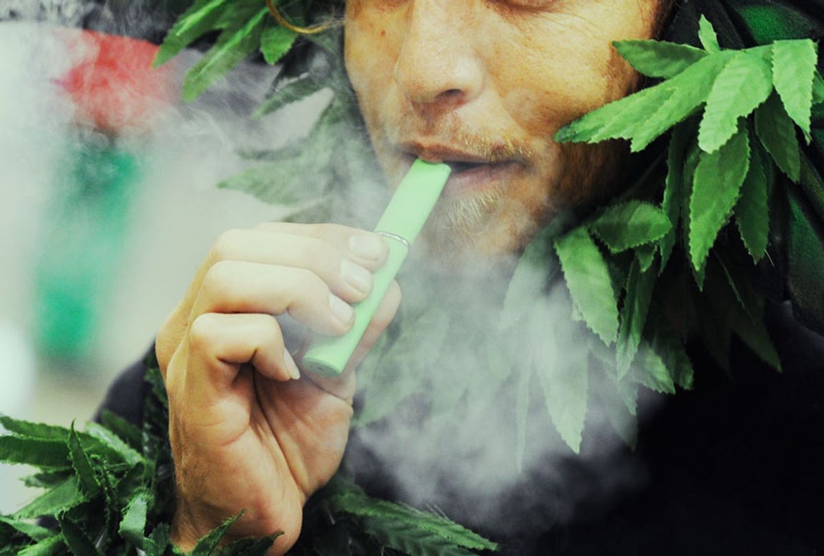 A man calling himself Henry Hemp inhales marijuana using a vaporizer pen at HempCon medical marijuana show (ROBYN BECK/AFP via Getty Images)