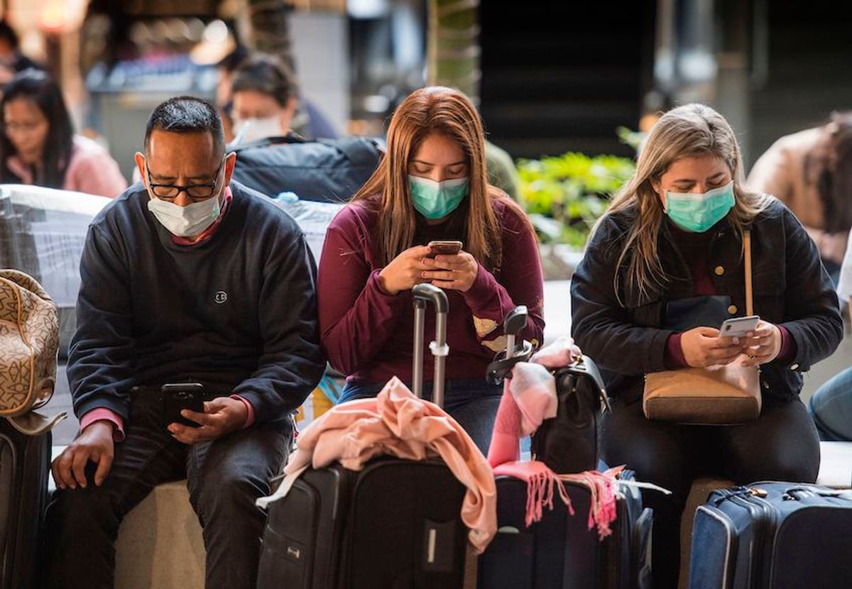 Passengers wear face masks to protect against the spread of the Coronavirus as they arrive on a flight from Asia at Los Angeles International Airport, California, on January 29, 2020. (Mark Ralston/AFP via Getty Images)