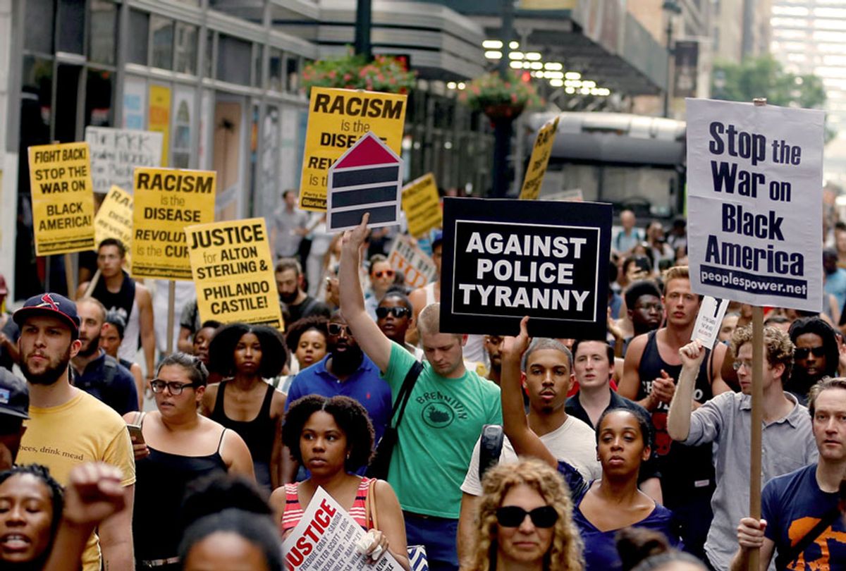 People hold banners and chant slogans as they march from Union Square Park to Grand Central to protest the killing of 3 black men by police in 48 hours, in Manhattan, New York on July 7, 2016.  (Volkan Furuncu/Anadolu Agency/Getty Images)