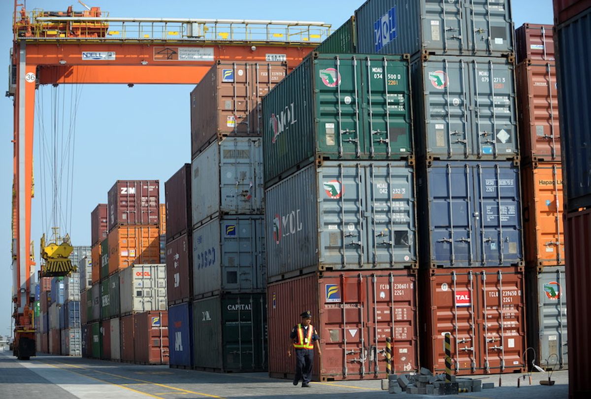 This photo taken on April 18, 2011, shows a security personnel walking past shipping containers at the International Container Terminal Services Incorporated (ICTSI) at a port in Manila.  (Noel Celis/AFP via Getty)