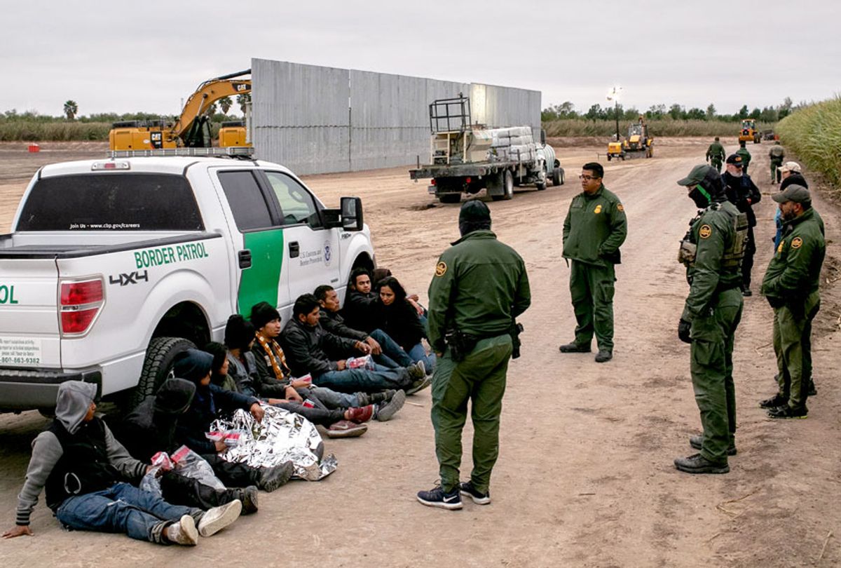 U.S. Border Patrol agents detain undocumented immigrants caught near a section of privately-built border wall under construction on December 11, 2019 near Mission, Texas. The hardline immigration group We Build The Wall is funding construction of the wall on private land along the Rio Grande, which forms the border with Mexico. The group, led by former Trump strategist Stephen Bannon claims to have raised tens of millions of dollars in a GoFundMe drive to build sections of wall along stretches of the U.S. southwest border with Mexico.  (John Moore/Getty Images)