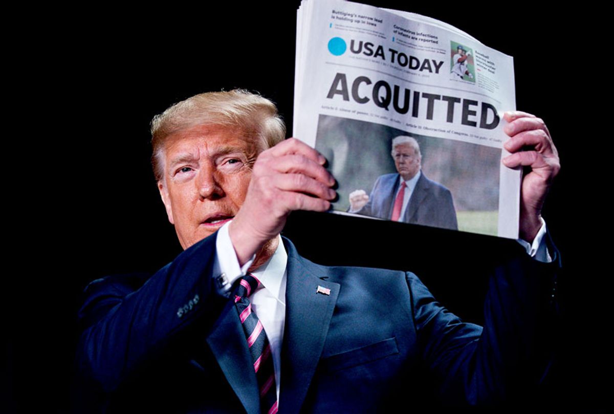 President Donald Trump holds up a newspaper with the headline that reads "ACQUITTED" at the 68th annual National Prayer Breakfast, at the Washington Hilton, Thursday, Feb. 6, 2020, in Washington.  (AP Photo/ Evan Vucci)