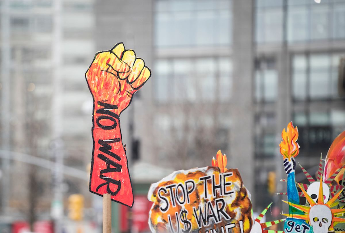 A marcher holds a sign that says "NO WAR" with a closed fist as protest outside of Trump International Tower during the Woman's March in the borough of Manhattan in NY on January 18, 2020, USA. (Ira L. Black/Corbis via Getty Images)
