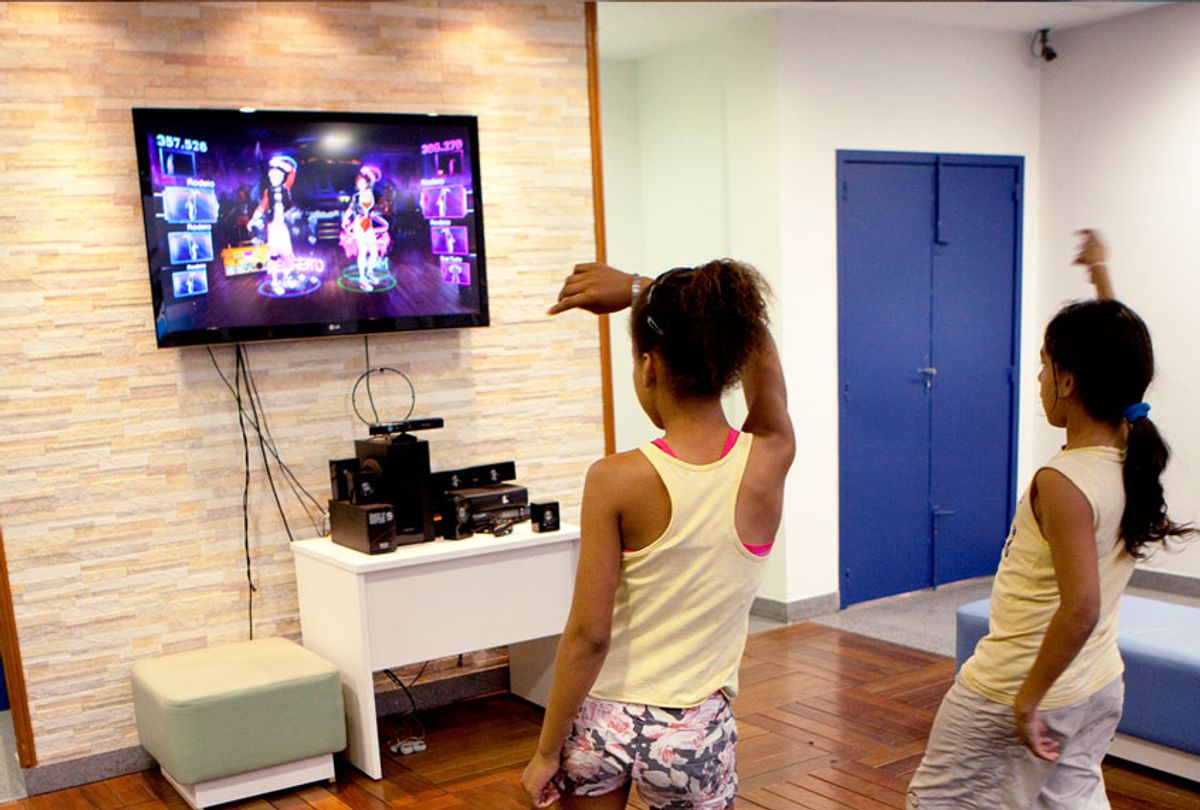 Poor children from favela Complex Alemao dance to an Xbox game in a community center, on September 13, 2012 in Rio de Janeiro, Brazil.  (Melanie Stetson Freeman/The Christian Science Monitor via Getty Images)