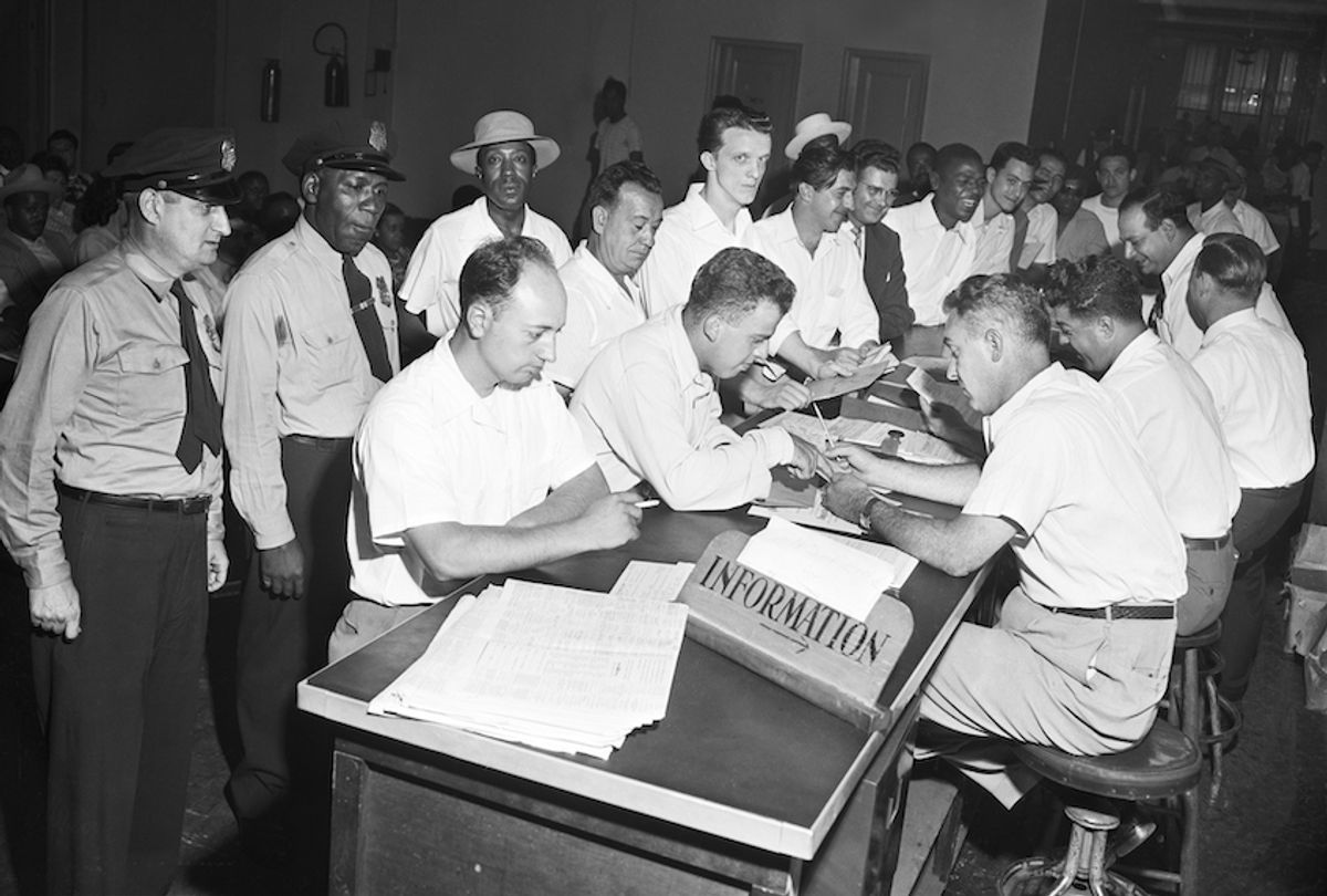 A crowd of veterans wait their turn to get counsel on schooling on the last day to file papers under the G.I. Bill in New York on July 25, 1951. (Bettmann/Getty Images)
