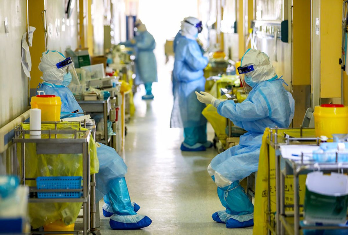 Nurses work in the aisle in a hospital designated for COVID-19 patients in Wuhan in central China's Hubei province Friday, March 06, 2020. (Feature China/Barcroft Media via Getty Images)