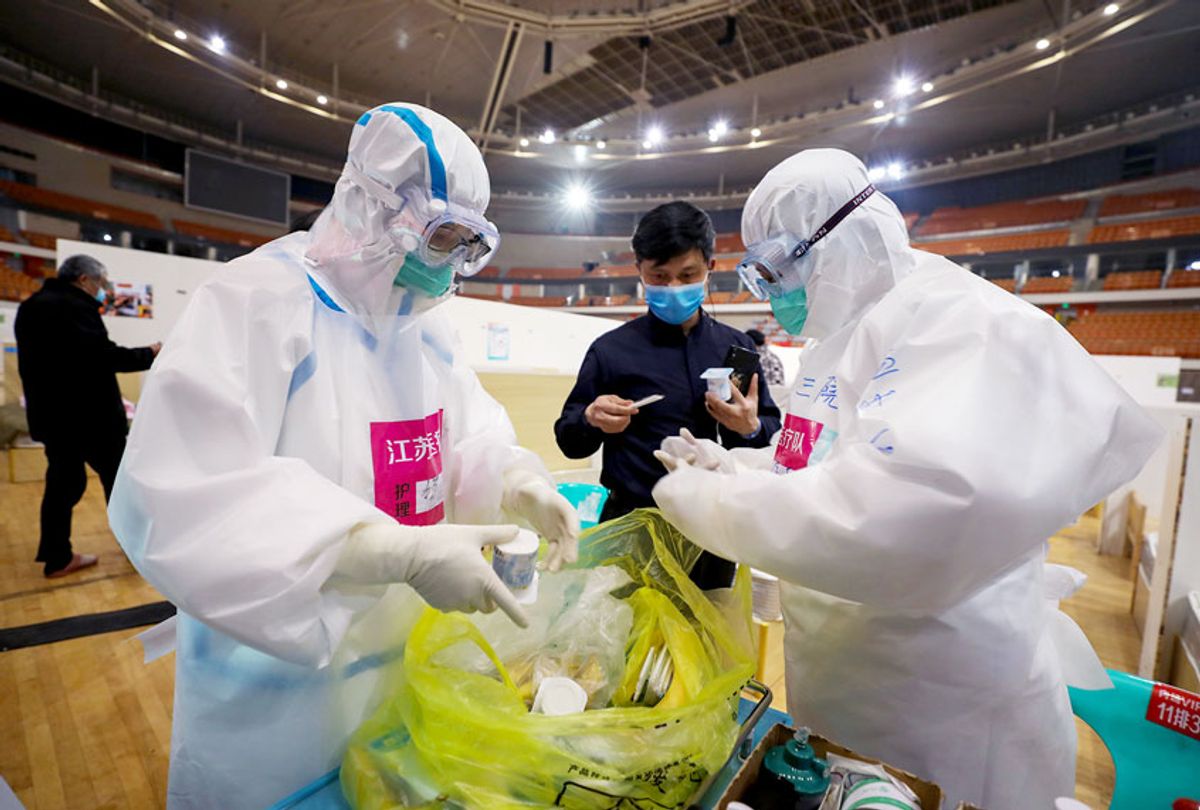 This photo taken on March 5, 2020 shows nurses preparing to deliver yoghurt to patients at a temporary hospital set up for COVID-19 coronavirus patients in a sports stadium in Wuhan, in China's central Hubei province. - China reported 30 more deaths from the new coronavirus outbreak on March 6, with fresh infections rising for a second straight day and 16 new cases imported from overseas.  (STR/AFP via Getty Images)