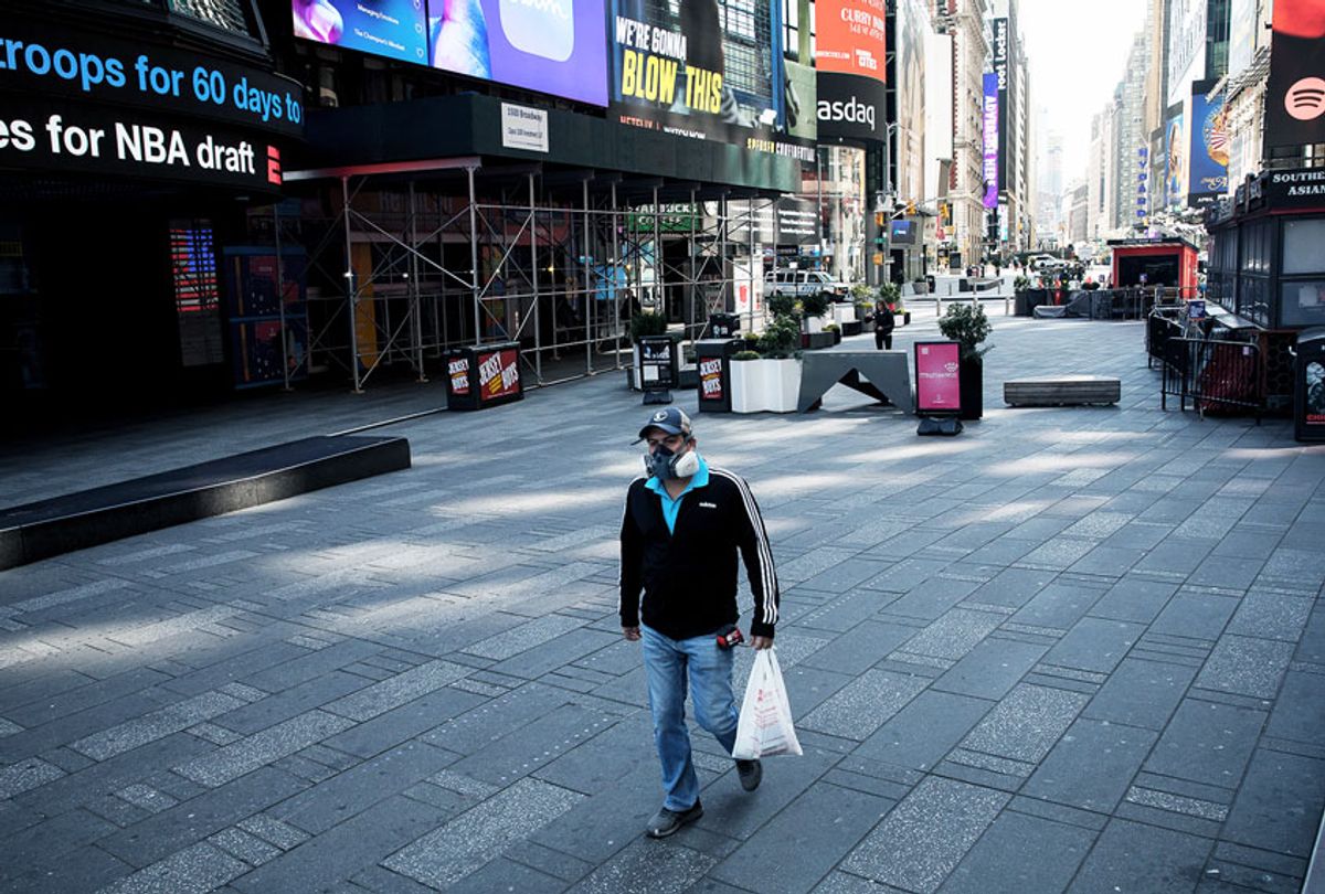 A man wearing a respirator walks through an eerily empty Times Square in New York, the United States, March 26, 2020 (Xinhua/M IchaelNagle/wangying via Getty Images)