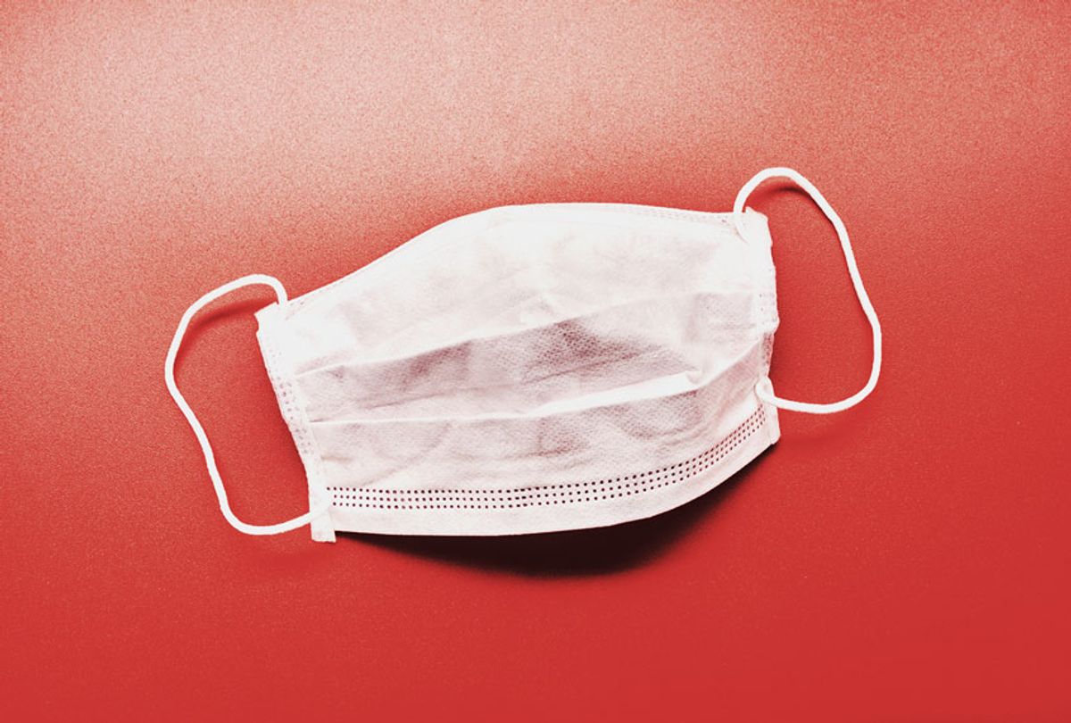 Still life of a face mask on red background (Getty Images)