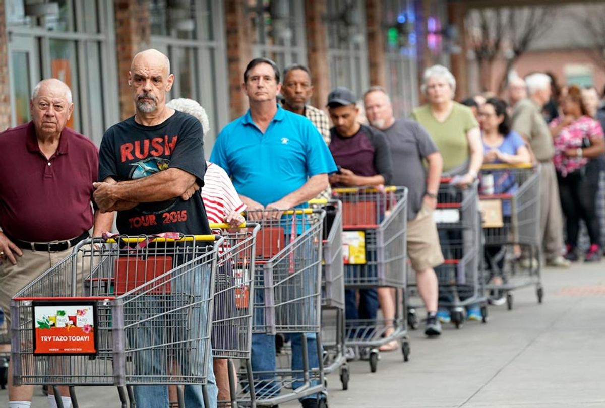 Some of the more than 150 people in line wait for an grocery store to open Tuesday, March 17, 2020 (AP Photo/David J. Phillip)