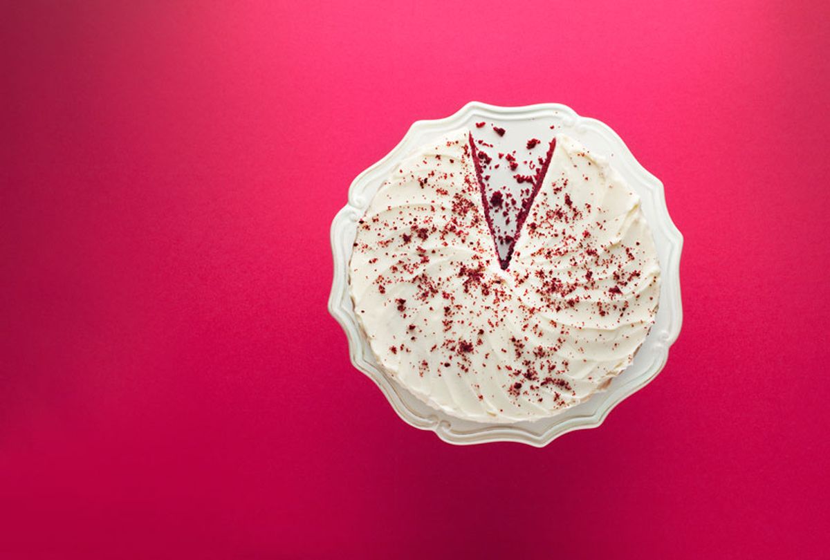 Slice missing from red velvet cake on a cakestand (Getty Images/ Martin Barraud)